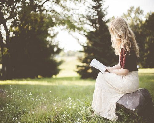 Person sitting with correct posture reading a book